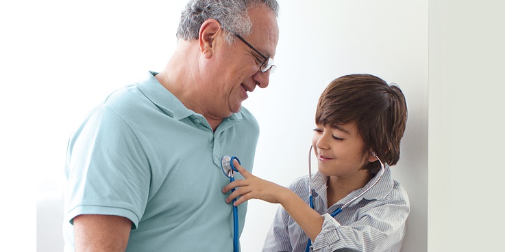 Boy and grandfather using stethoscope