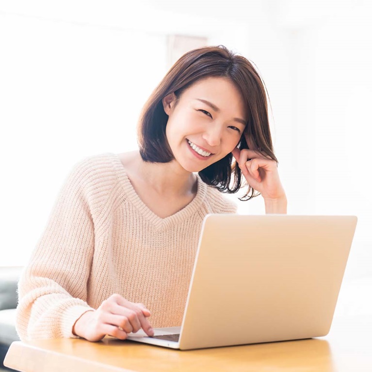 Asian woman using laptop.