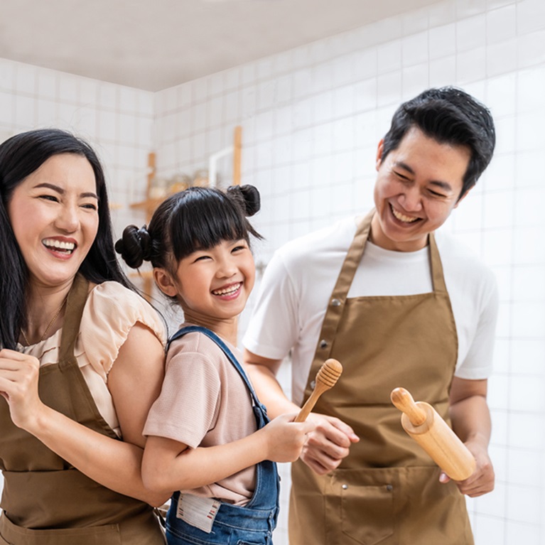 A family is laughing in a kitchen