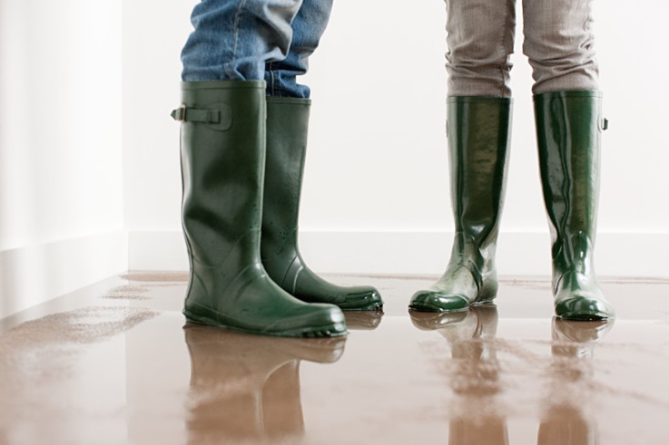 close up photo of the feet of 2 people wearing rubber boots